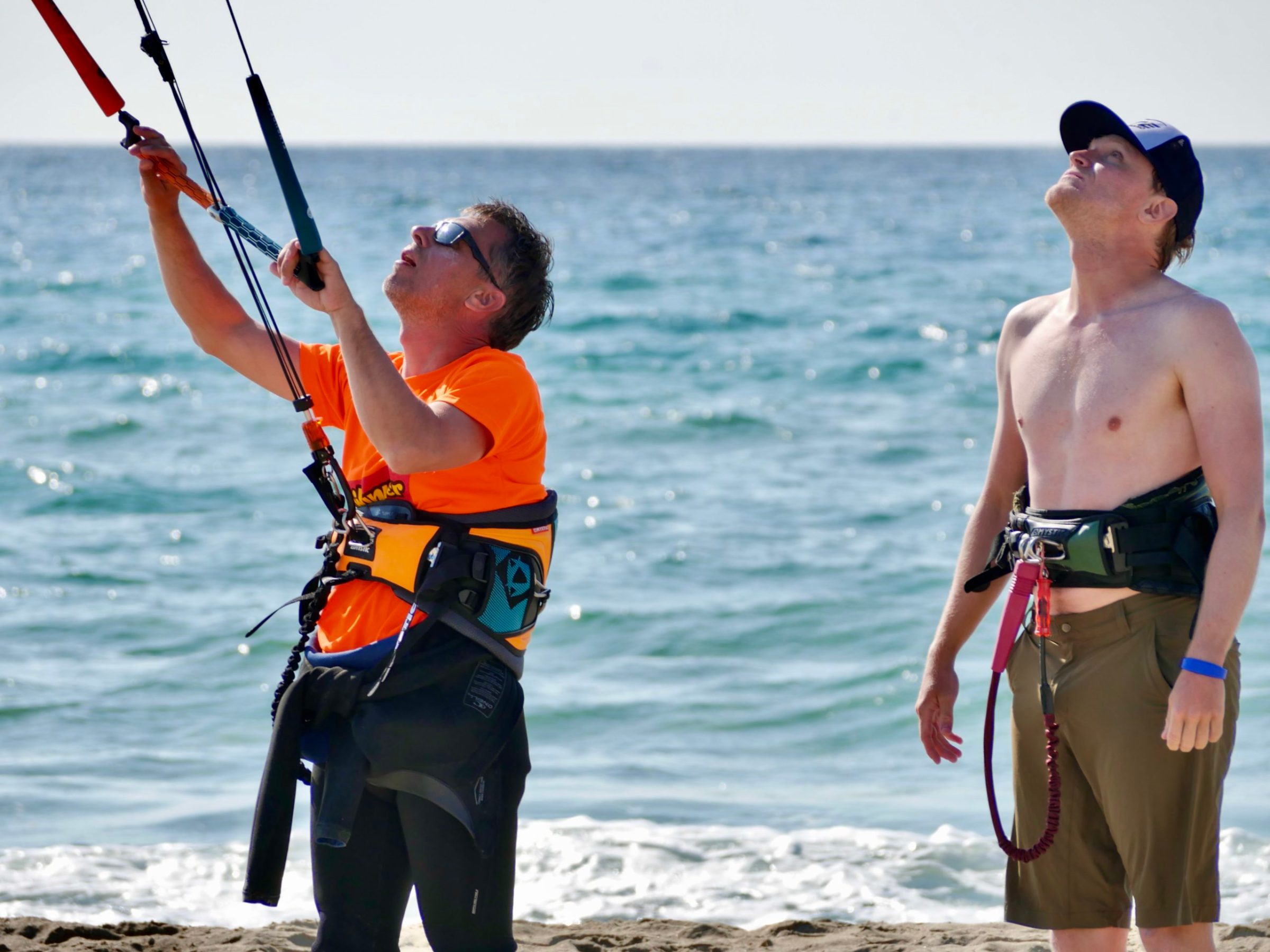 a couple of people that are standing in the ocean