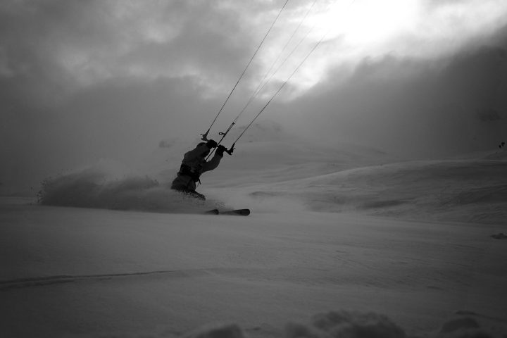 a person flying through the air on a cloudy day