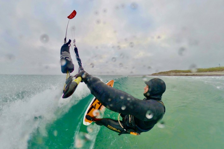 a man riding a wave on a surfboard in the water