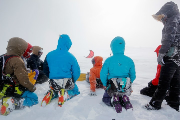 a group of people sitting in the snow