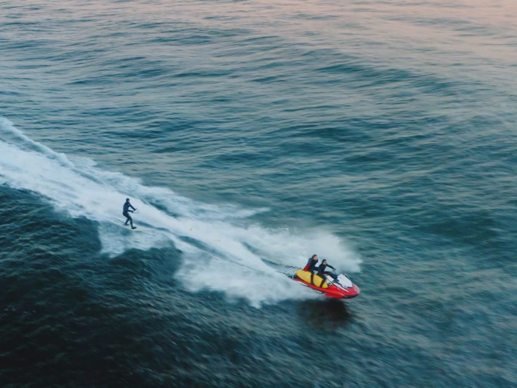 a man riding a wave on a surfboard in the water