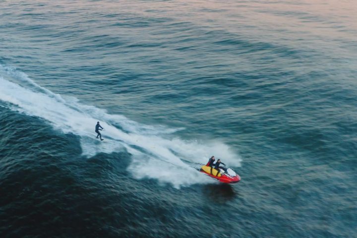 a man riding a wave on a surfboard in the water