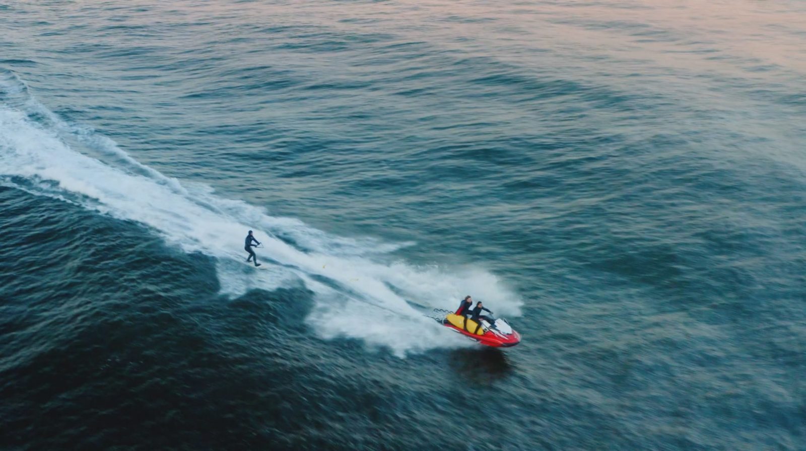 a man riding a wave on a surfboard in the water