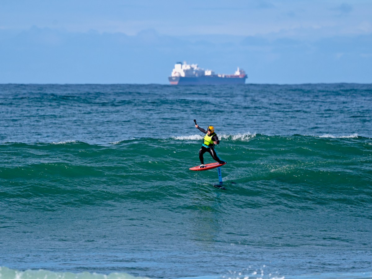 a man riding a wave on a surfboard in the ocean