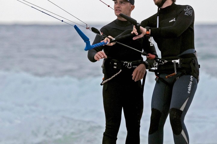 a person holding a kite on the beach
