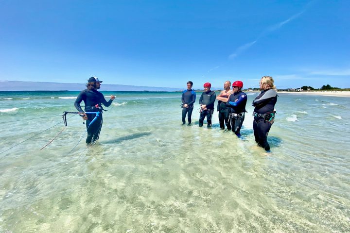 a group of people surfing in the ocean