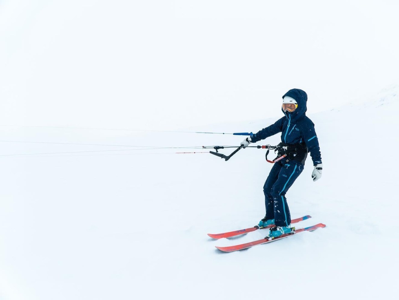 a man riding skis down a snow covered slope