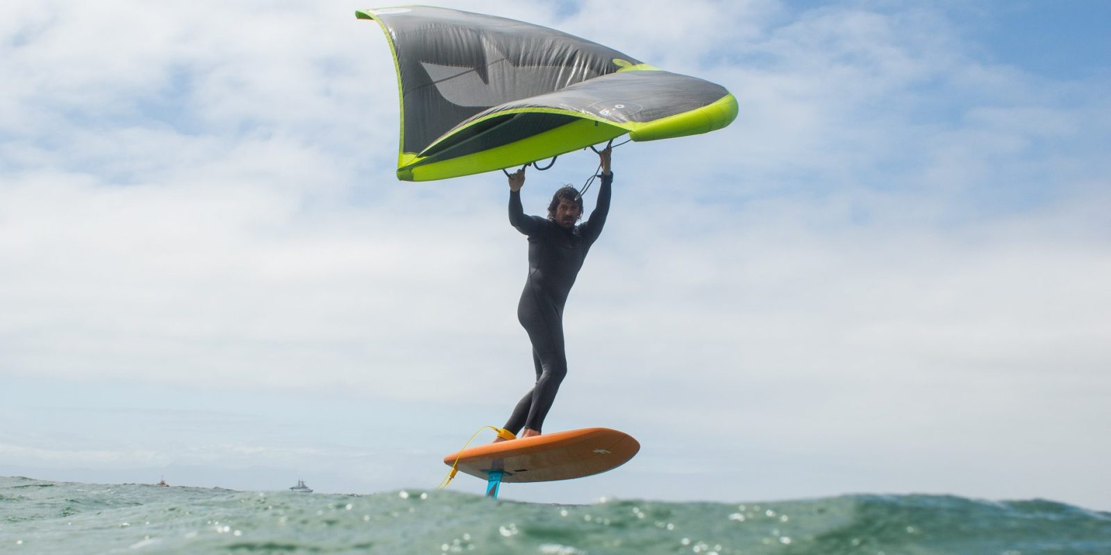a man flying through the air while holding a frisbee in the water