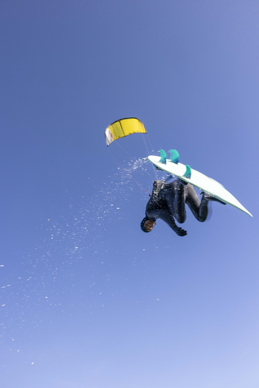 a man flying through the air while riding a snowboard