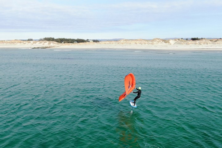 a man standing next to a body of water