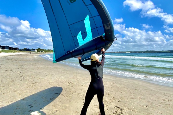 a person standing on top of a sandy beach