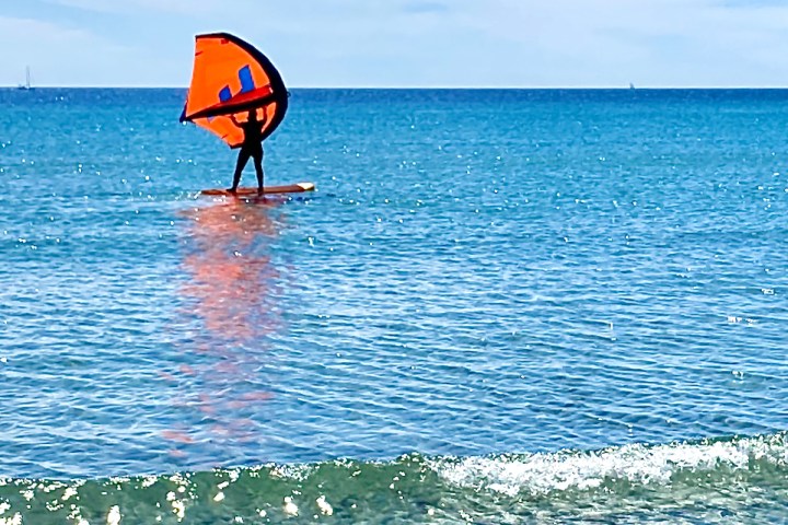 a person standing next to a body of water