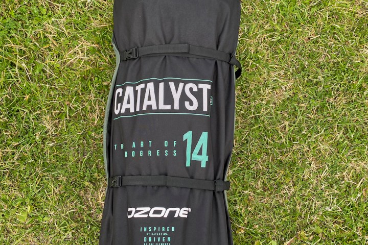 a bag of luggage sitting on top of a grass covered field