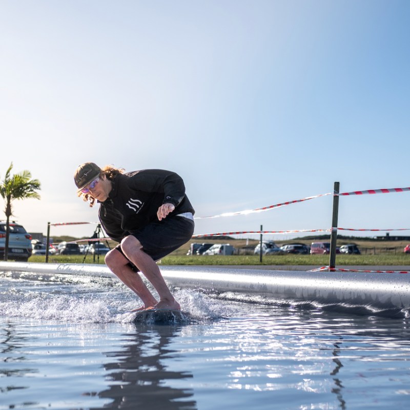 a man riding a skimboard in a pool