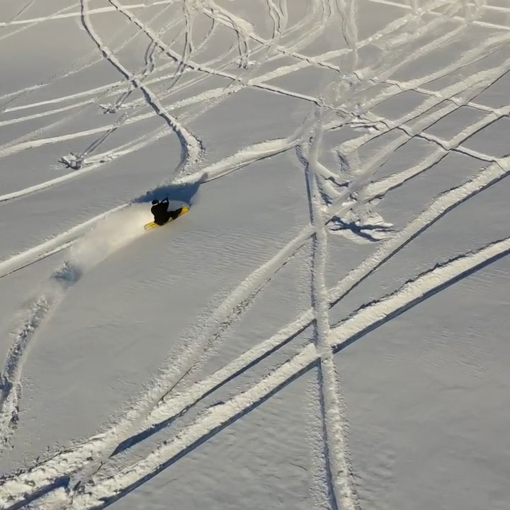 a man riding snowboard uphill