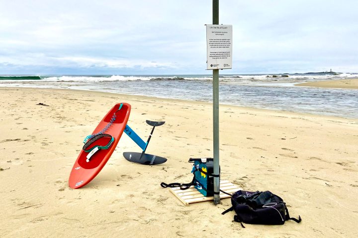 a beach with a foilsurfboard in the sand