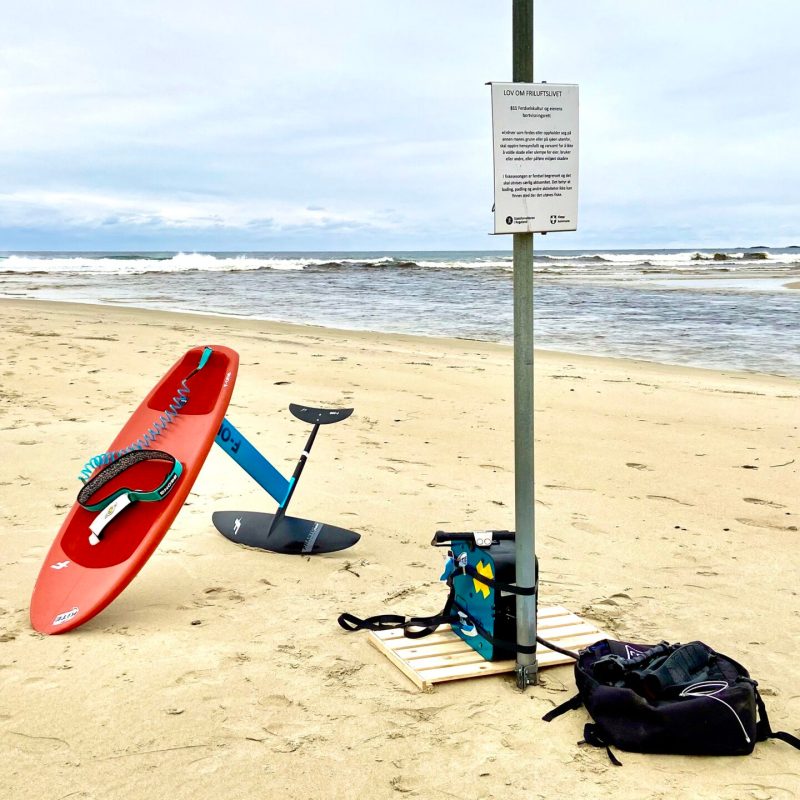 a beach with a foilsurfboard in the sand