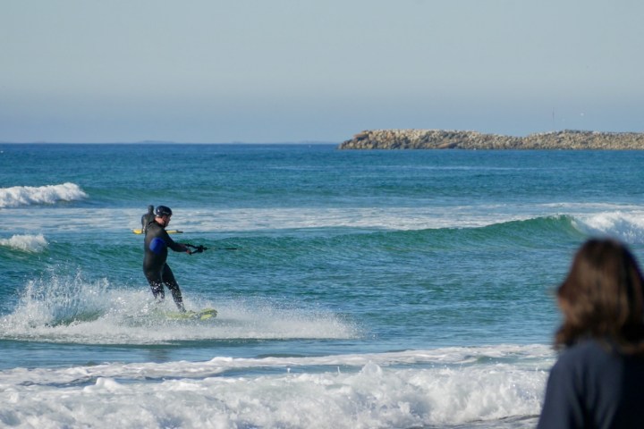 a man riding a wakeboard in the ocean
