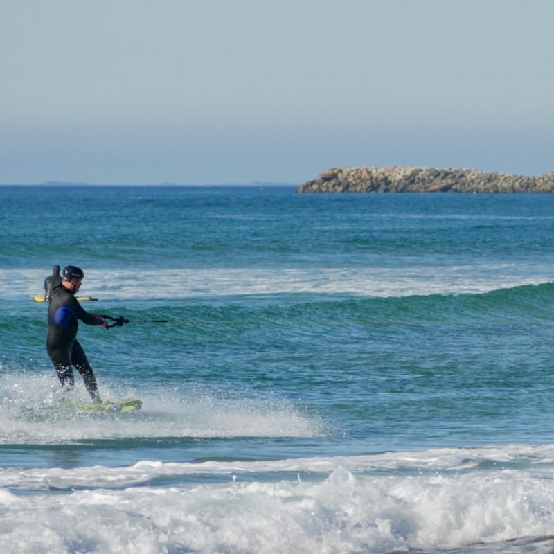 a man riding a wakeboard in the ocean